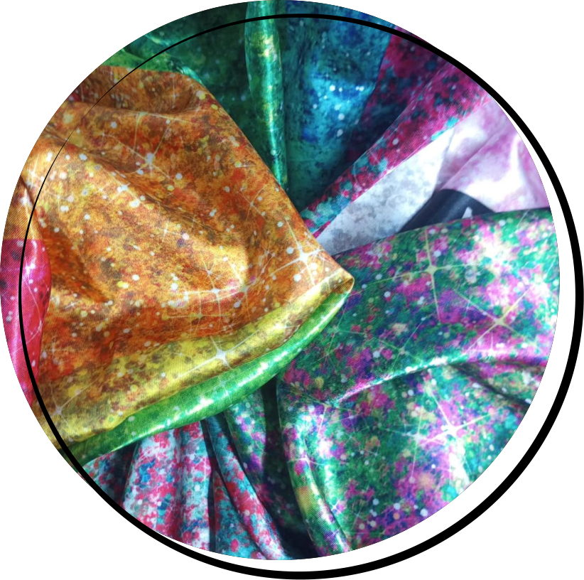 A rainbow of faux glitter printed on satin fabric.