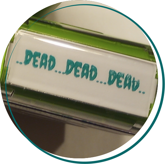 A rubber stamp saying ..Dead...Dead...Dead..